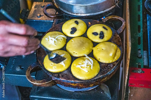 Kue Lumpur Bolak Balik or flip flop mud cake. A crispy outer layer embracing a soft, indulgent center. Traditional cake at Pasar Oro Oro Dowo in Malang, East Java, Indonesia. photo