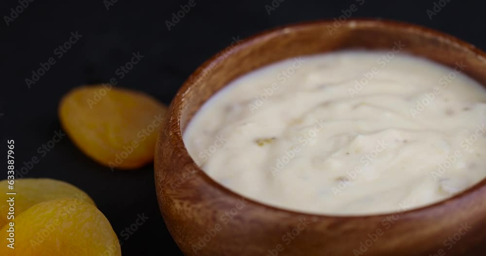 fresh yogurt made from milk with pieces of dried apricots , bio yogurt with the addition of soft dried apricots fresh yogurt made from milk with pieces of dried apricots , bio yogurt with the addition of soft dried apricots