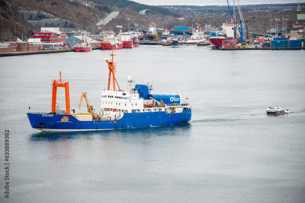 Fototapeta premium St. John's, Newfoundland, Canada- OceanGate-May 29, 2023: Polar Prince towing OceanGate Expeditions submersible vessels on a barge as it leaves for the Titanic wreck site to tour below the ocean.
