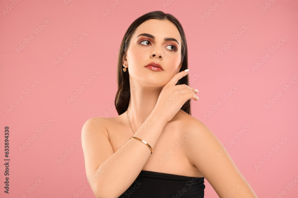 Beautiful woman with elegant jewelry on pink background Beautiful woman with elegant jewelry on pink background