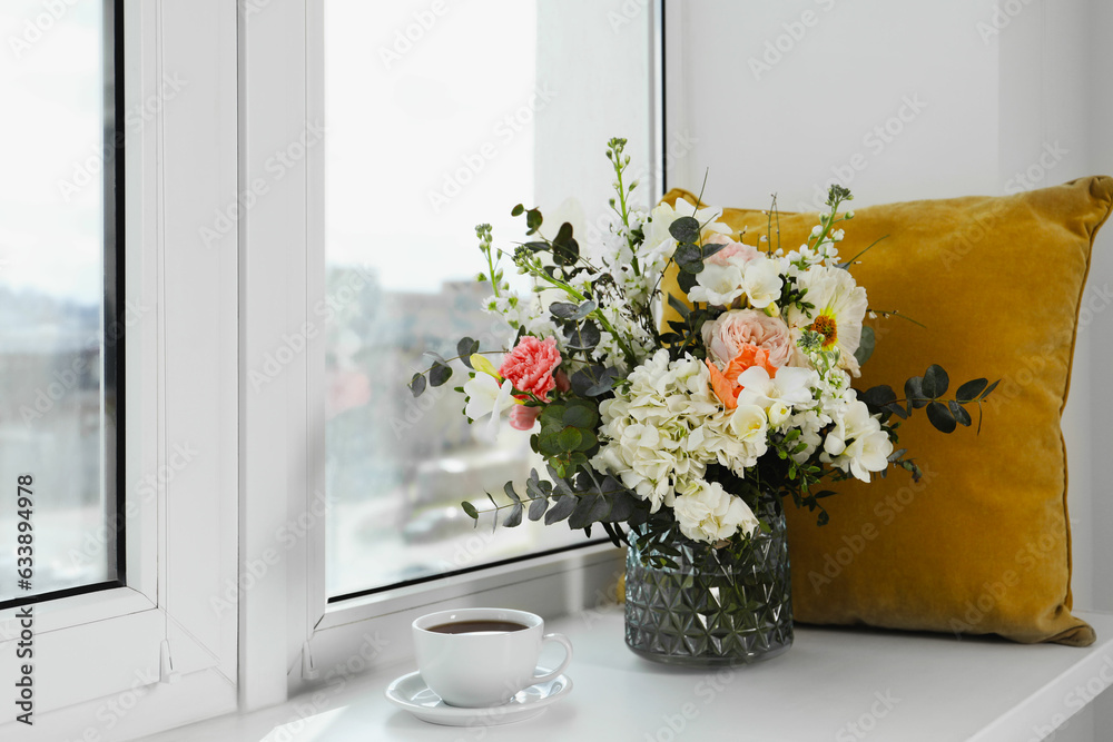 Bouquet of beautiful flowers and coffee on windowsill Bouquet of beautiful flowers and coffee on windowsill