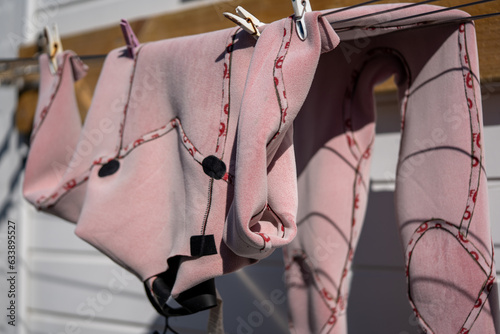 wetsuit clothes drying on a clothesline photo