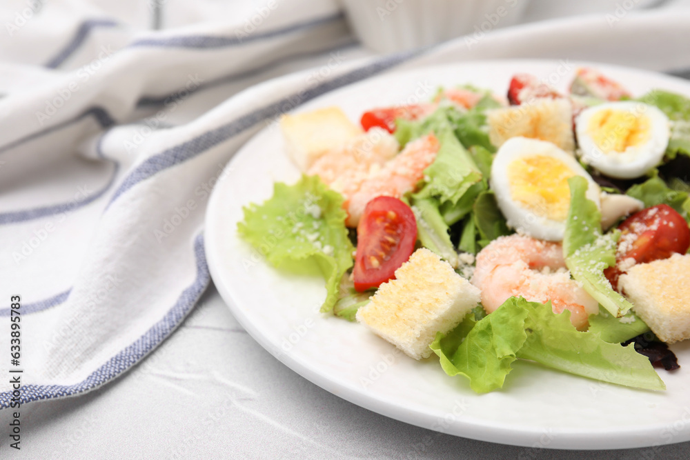 Delicious Caesar salad with shrimps on white table, closeup. Space for text Delicious Caesar salad with shrimps on white table, closeup. Space for text