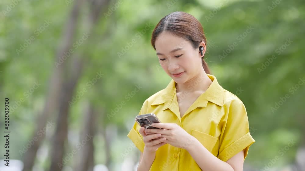Asian woman standing with smartphone traveling alone in the city Asian woman standing with smartphone traveling alone in the city