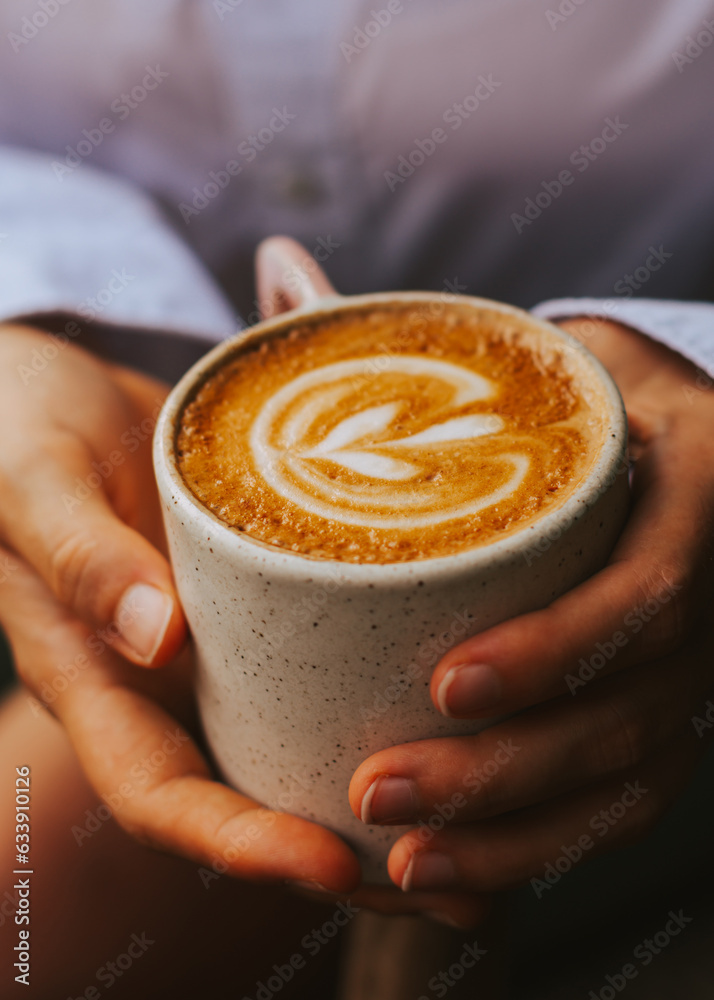 Women's hands hold delicious specialty coffee of excellent quality. Hot cappuccino at brunch in a cafe Women's hands hold delicious specialty coffee of excellent quality. Hot cappuccino at brunch in a cafe