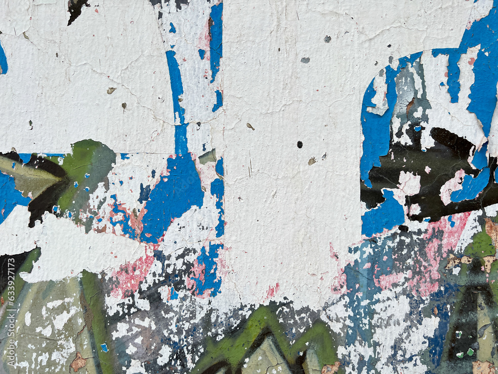 Fototapeta premium Grungy, distressed layers of peeling paper on a wall in Mexico
