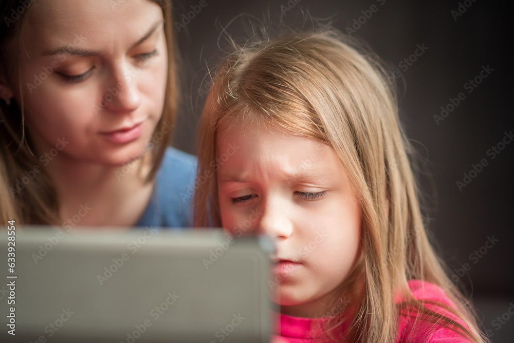 Close-up portrait of mother and daughter.