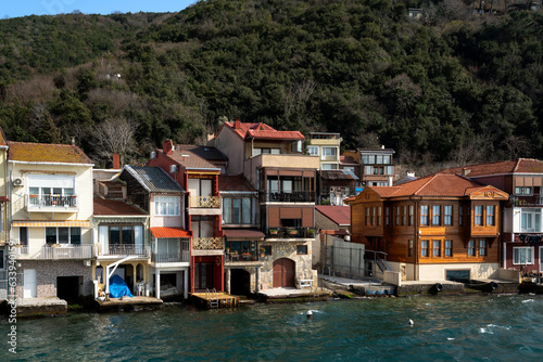 View of residential buildings in the fishing village of Kanadolu Kavagi on the shore of the Bosphorus Strait on a sunny day, Istanbul, Turkey photo