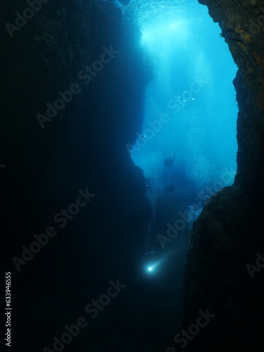 cave diving underwater scuba divers exploring caves and having fun ocean scenery