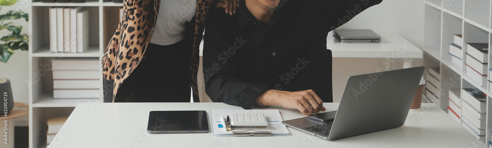 Entrepreneur Asian businessman and businesswoman discussing new business project in tablet in modern Meeting In Modern Office, Asian business casual concept. - obrazy, fototapety, plakaty 