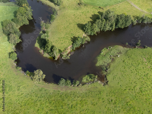 Aerial, drone view of river, green fields and trees. Nature landscape photography taken from above in Sweden in summer in August. Copy space and place for text. photo