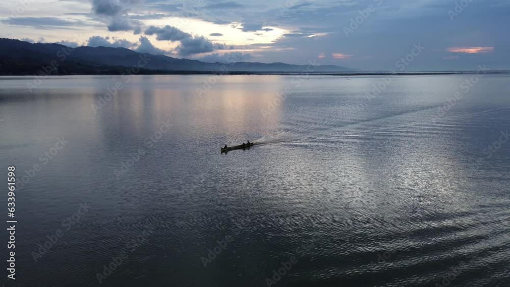 aerial view of a fisherman on his boat in the lake
aerial view of a fisherman on his boat in the lake