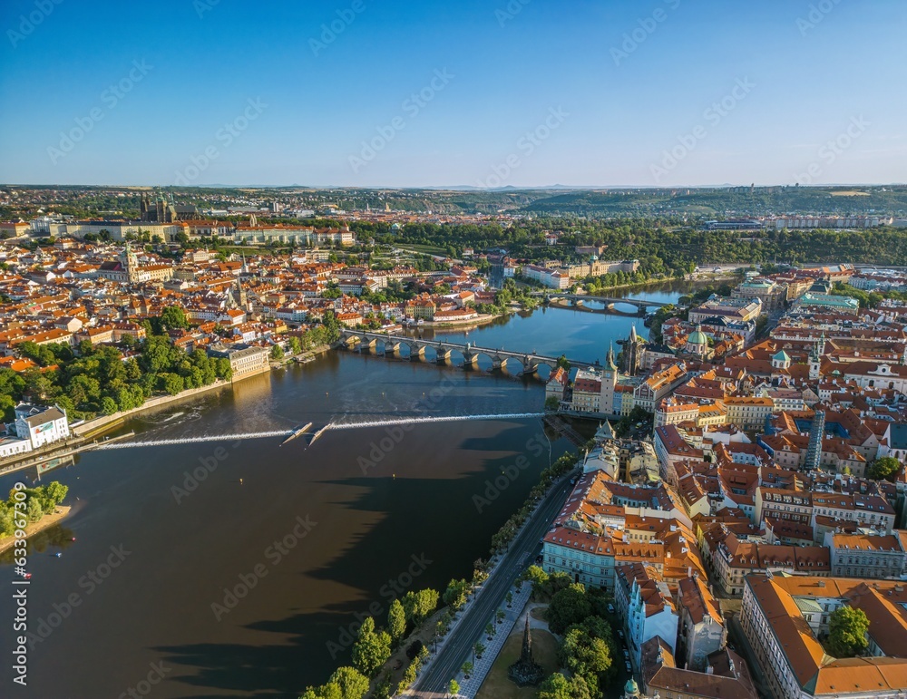 The drone aerial panoramic view of River Vltava runs through Prague city at sunrise, Czech Republic.	