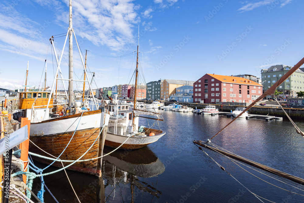 Wandering the banks of the Nidel river in Trondheim city, with old sea houses and veteran boats, Trøndelag, Norway