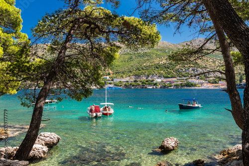Fototapeta Naklejka Na Ścianę i Meble -  A beautiful bay at the Dalmatian Coastal line close to Dubrovnik with crystal clear and turquoise waters, creating a feeling of paradise
