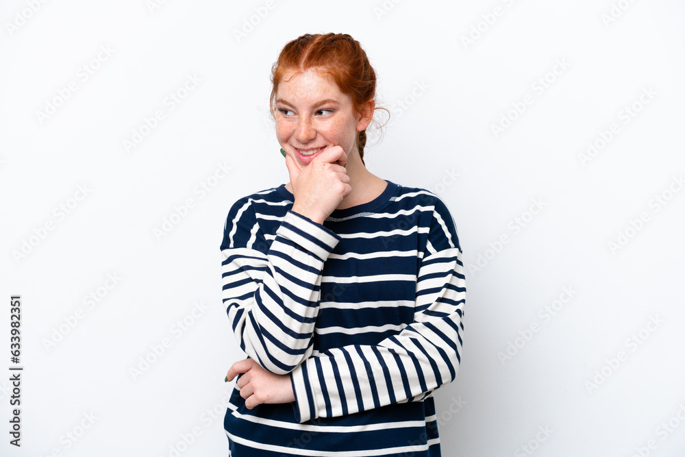 Young reddish woman isolated on white background looking to the side and smiling Young reddish woman isolated on white background looking to the side and smiling