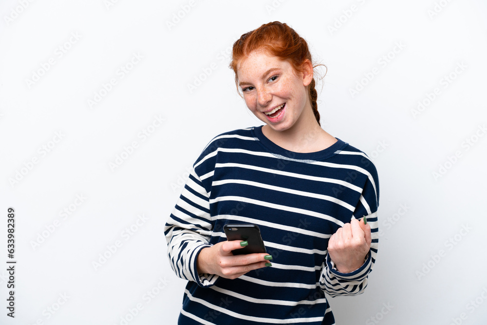 Young reddish woman isolated on white background with phone in victory position Young reddish woman isolated on white background with phone in victory position