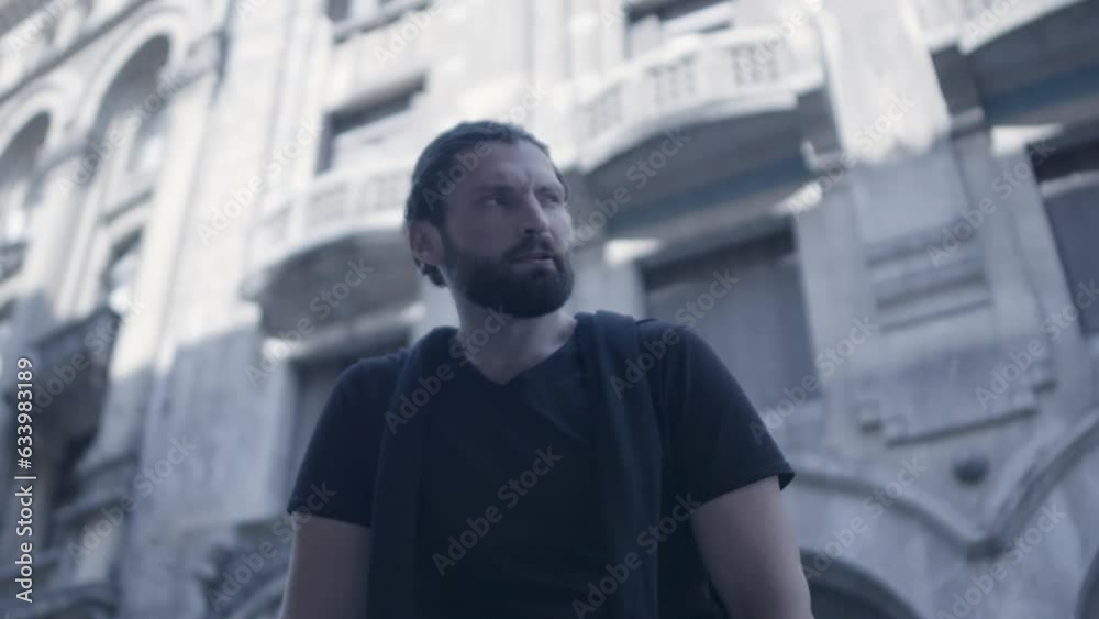 Closeup of pensive bearded man looking at the camera in slow motion Closeup of pensive bearded man looking at the camera in slow motion