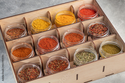 Fototapeta Naklejka Na Ścianę i Meble -  A set of spices on a light background in a glass bowl. Enhancement of taste.