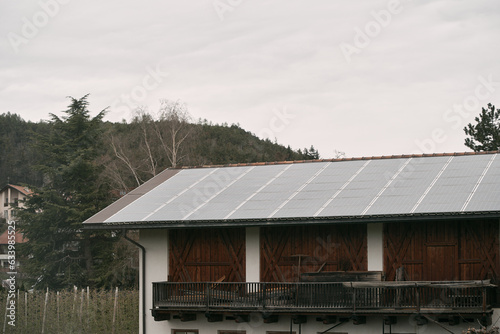Wallpaper Mural House roof with solar panels installed. The integration of solar technology into the roof tiles highlights the innovative approach to energy generation, offering an alternative source of electricity. Torontodigital.ca