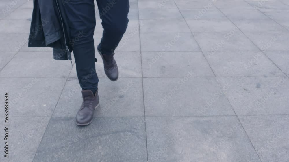 Closeup of leather brown shoes of walking man in slow motion Closeup of leather brown shoes of walking man in slow motion