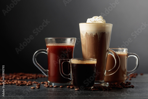 Various coffee and chocolate drinks on a black table.