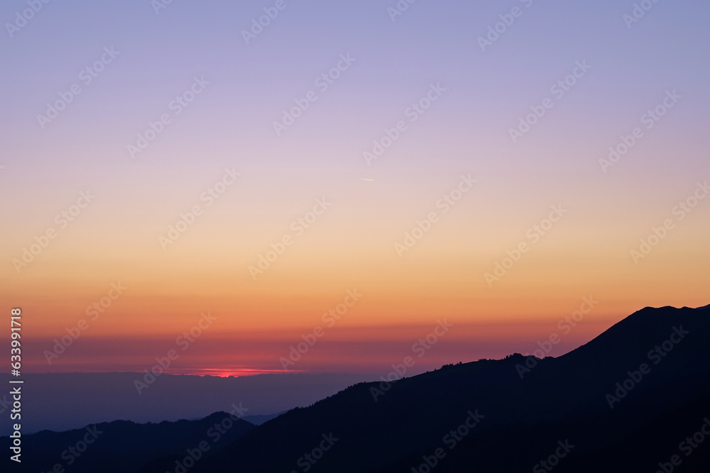 Silhouette of a mountain range before sunrise