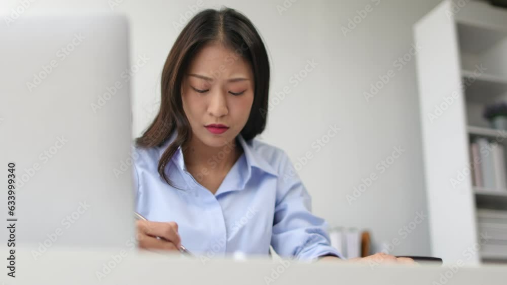 Serious businesswoman is busy and stressed with paperwork in the office. Serious businesswoman is busy and stressed with paperwork in the office.