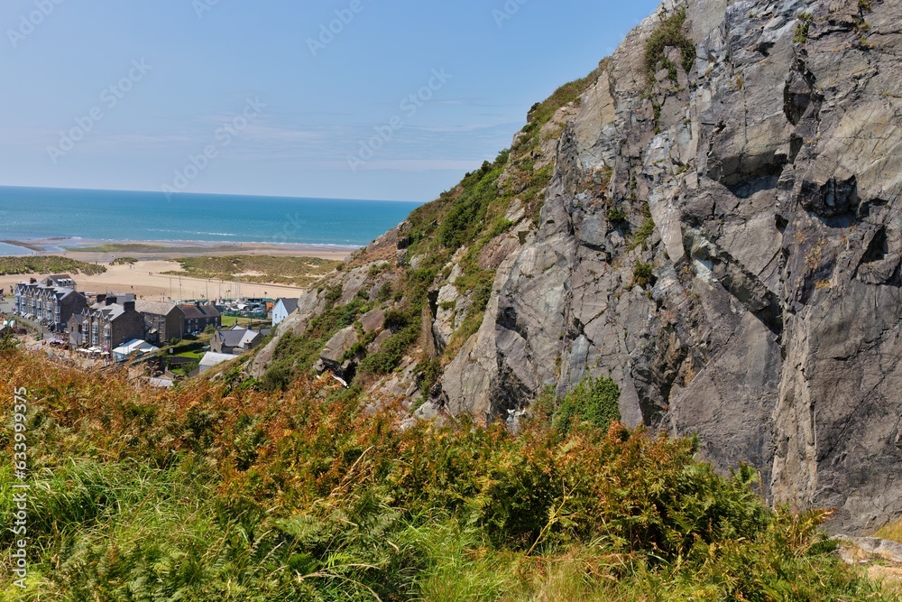 a fragment of a rocky mountain and a view of the town and the sea in Barmouth, UK