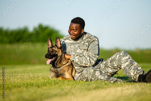 Military working dog and soldier bonding together.