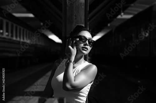 portrait of beautiful fashion business woman posing in attic interior, model looking up, woman wearing glasses, black and white