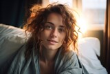 Portrait of a beautiful woman sitting on a bed