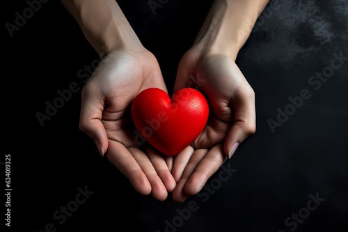 hands holding red heart  health care  love  organ donation  mindfulness  wellbeing  family insurance and CSR concept