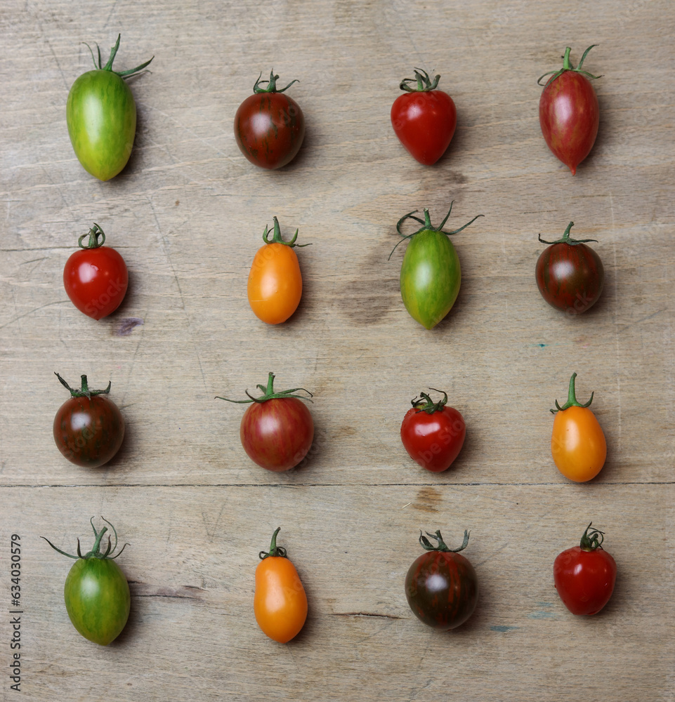 a variety of fresh multicolored tomatoes on a wooden table a variety of fresh multicolored tomatoes on a wooden table