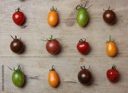 a variety of fresh multicolored tomatoes on a wooden table