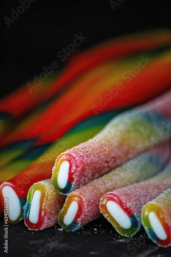 Fotografía Colorful Long sticky jelly candies on black background, closeup of photo