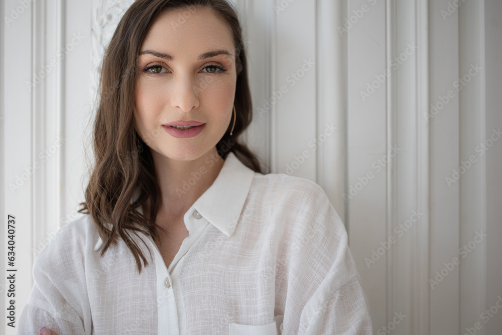 Stylish confident woman in a white shirt, close-up portrait. Natural beauty, woman 35-45 years old Stylish confident woman in a white shirt, close-up portrait. Natural beauty, woman 35-45 years old