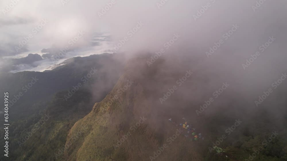 High angle view of camping in the mountains Of people who come to walk in the forest, covered with fog, the light in the morning or evening is beautiful. High angle view of camping in the mountains Of people who come to walk in the forest, covered with fog, the light in the morning or evening is beautiful.