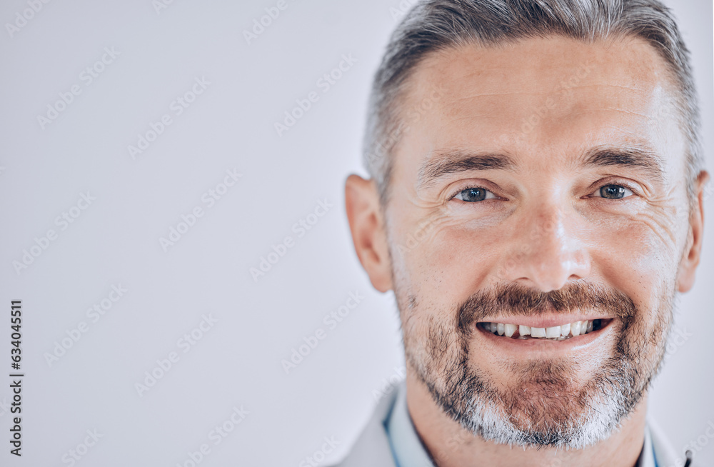 Doctor man, headshot and space with smile in portrait, mockup or promotion for hospital employee. Healthcare professional, expert and mature leader with face by wall background for wellness in clinic Doctor man, headshot and space with smile in portrait, mockup or promotion for hospital employee. Healthcare professional, expert and mature leader with face by wall background for wellness in clinic