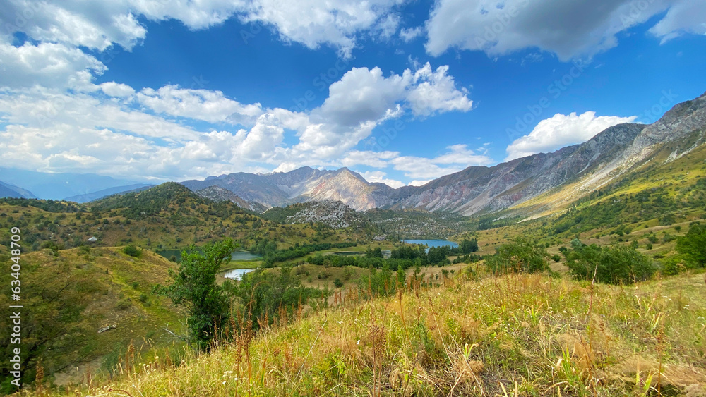 Beautiful mountain summer landscape. Sary Chelek State Biosphere Reserve. View from the height of the lakes, mountains, ridges and slopes of Kyrgyzstan.