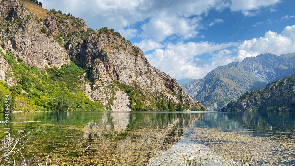 Transparent mountain lake. Sary Chelek State Biosphere Reserve. Specially protected natural territory of Kyrgyzstan. Amazing mountain summer landscape.