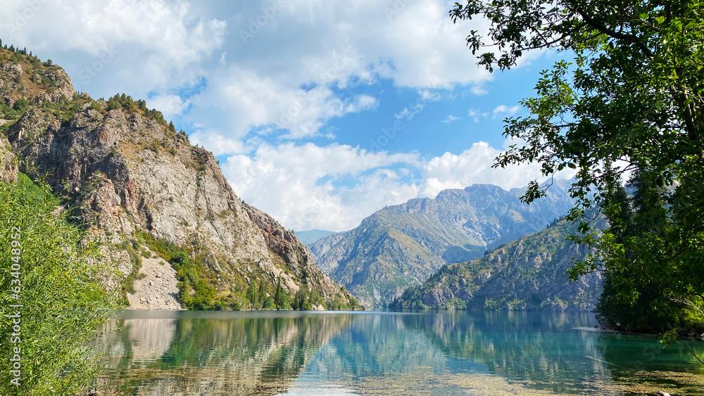 Summer vacation in the mountains of Kyrgyzstan on the shore of the amazing lake Sary Chelek. The State Biosphere Reserve is a specially protected natural territory of Kyrgyzstan.