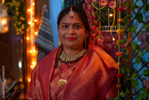 a portrait of an indian woman in traditional dress during diwali celebration