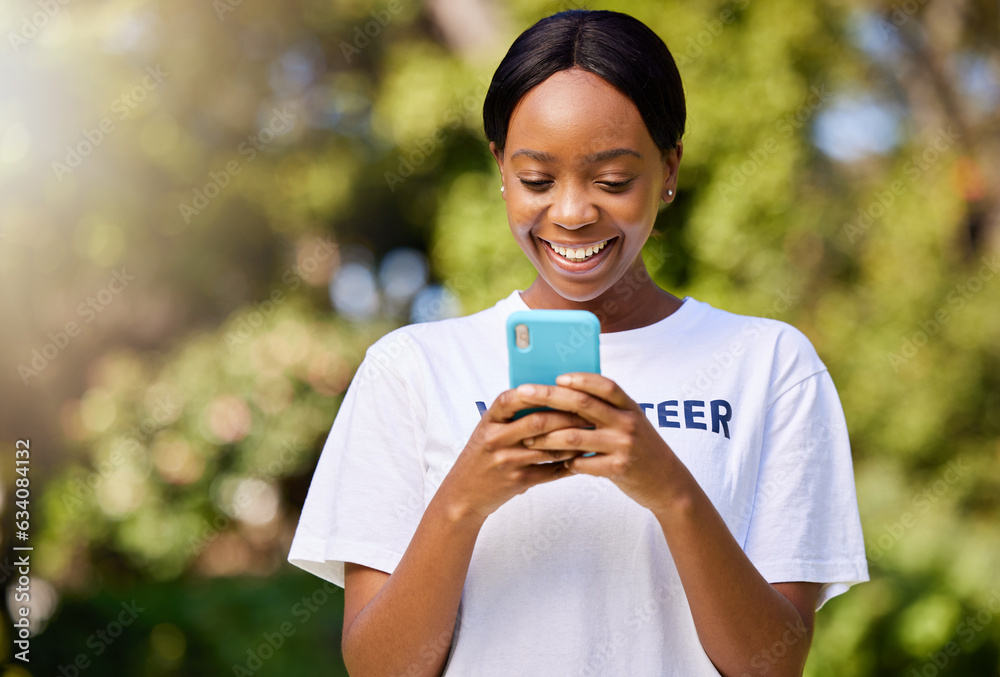 Smile, park volunteering and black woman with a phone for social media, chat or communication. Happy, web and African volunteer or charity worker in nature for cleaning with a mobile for notification