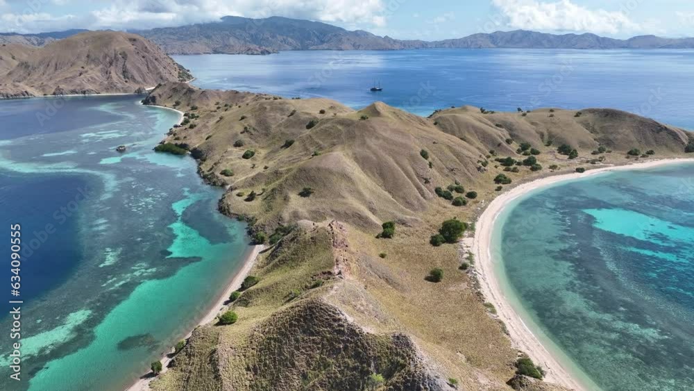Beautiful coral reefs fringe the scenic island of Gili Lau Laut in Komodo National Park, Indonesia. This island's coral reefs harbor extraordinary marine biodiversity and are often visited by divers. 