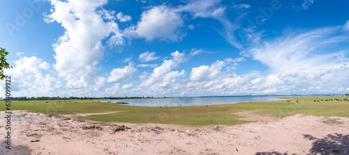 Lake, many white clouds in the blue sky