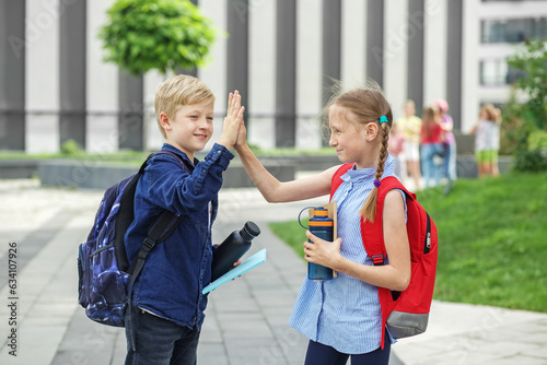 Back to school. High five. Classmates meeting. Beginning of school lessons. Reusable water bottle
