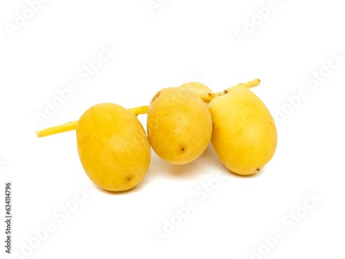 Fresh date palm yellow chemical free placed on a white background.
