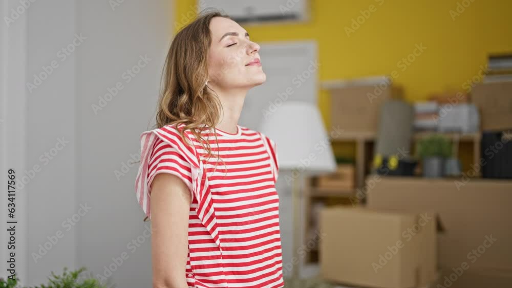 Young blonde woman breathing at new home Young blonde woman breathing at new home