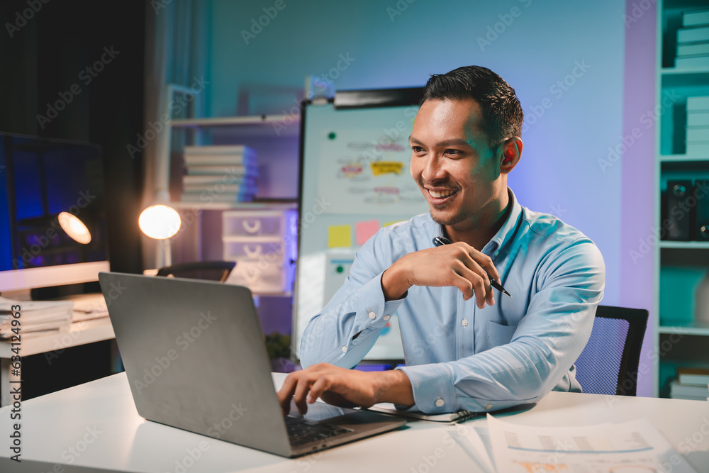 business man working late at night use laptop at desk Happy male portrait working IT, face and male coder or person programming Coding and Writing for Software or Information Technology Development